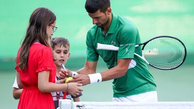 Serbia's Novak Djokovic signs autographs. AP Photo