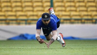 India’s Virat Kohli dives to catch the ball during a training session ahead of their second Test against South Africa on Friday. Aijaz Rahi / AP