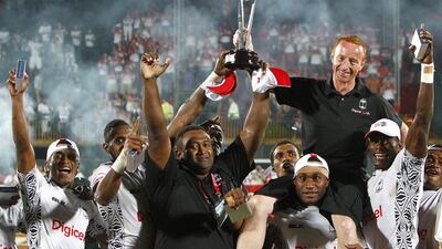 Coach Ben Ryan is hoisted by the Fijian team after they beat New Zealand in the cup final and won the Dubai Rugby Sevens last year. Jake Badger / The National