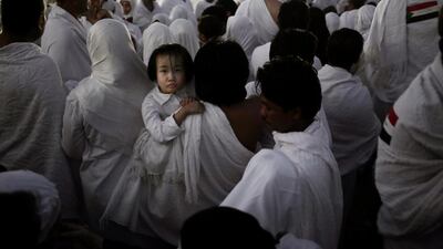 An Indonesian father carries his daughter through the crowd after reaching the top of the Mountain of Mercy. Nariman El-Mofty / AP Photo