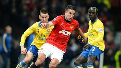 Robin van Persie, centre, delivered the biggest blow yet to Arsenal's Premier League title hopes on Sunday night. Paul Ellis / AFP