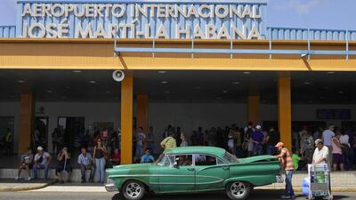 People load luggage from a Miami charter flight onto a car at Jose Marti International Airport in Havana. Cuba has raised duties and restricted imports on consumer goods brought in by air travelers or sent by mail. Enrique De La Osa / Reuters