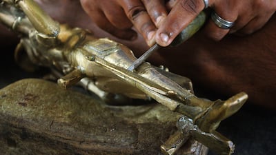 Carving into a bronze statue