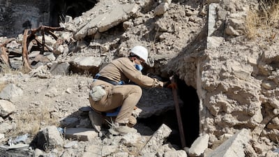 A member of a demining squad takes part in an operation to clear mines in the Old City of Mosul.