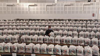 An employee of the Tunisian Social Solidarity Union prepares food packages for the elderly and low-income families in Tunis. AFP