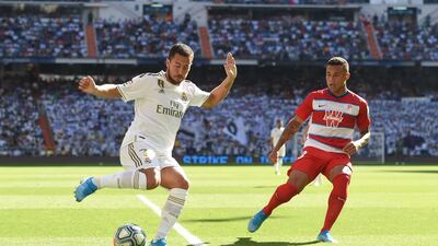 Eden Hazard of Real Madrid shields the ball from Darwin Machis of Granada. Getty