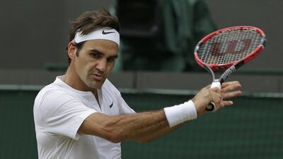 Roger Federer of Switzerland plays a return to Gilles Simon of France during the men's quarter-final singles match at the All England Lawn Tennis Championships in Wimbledon, London, Wednesday July 8, 2015. (AP Photo/Pavel Golovkin)