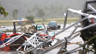 Ruined vehicles sit in the water in Anyer. EPA