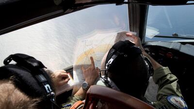 Flight Lt Jayson Nichols looks at a map as he flies aboard a Royal Australian Air Force AP-3C Orion aircraft during a search operation of the missing Malaysian Airlines flight MH370 over the southern Indian Ocean. Michael Martina / AP Photo