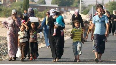 Syrian refugees walk out of Kilis, Turkey, at the border with Syria after clashing with police during a demonstrating over their living conditions on Sunday. But thoughts of returning to Syria have been tempered by the widely-held belief that violence will not cease with the toppling of the regime. AFP