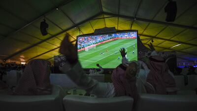 Saudi football supporters react while watching their national team play during their Russia 2018 World Cup Group A football match against Uruguay at a fan tent in the Red Sea coastal resort of Jeddah on June 20, 2018. Amer Hilabi / AFP