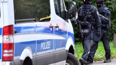 Policemen of a special unit are pictured at the Yorckgebiet district of Chemnitz, eastern Germany, where German police commandos hunting a fugitive Syrian bomb plot suspect raided a flat on October 9, 2016. Security was stepped up at airports and train stations as it was unclear whether the fugitive, Jaber Albakr, 22, was carrying more bomb-making material or weapons. Hendrik Schmidt/AFP