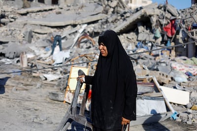 A Palestinian woman at the site of a house in Deir Al Balah, central Gaza, whose occupants were warned to leave before it was attacked on Sunday. Reuters