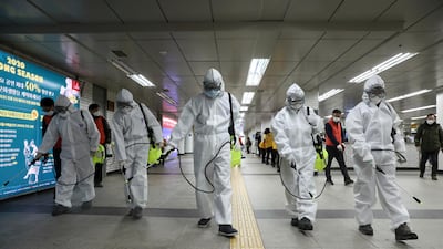 Workers disinfect as a precaution against coronavirus at a subway station in Seoul, South Korea, Wednesday, March 11, 2020. AP