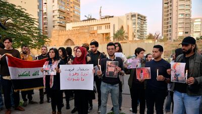 Lebanese activists hold candles during a protest to support children taking part in the uprising in front of the Iraqi embassy in Beirut. EPA