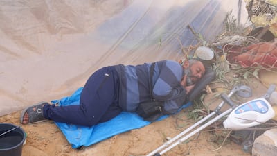 A displaced Palestinian, who fled his home from Israeli strikes, grabs some sleep at a camp in Rafah in the southern Gaza Strip. Reuters