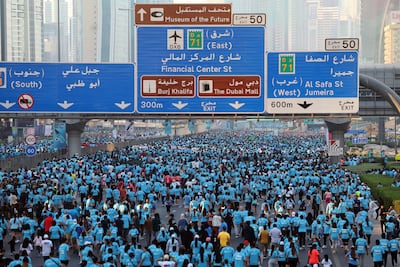 Runners take part in the Dubai Run 2025 on Sheikh Zayed Road as part of the Dubai Fitness Challenge 30x30. Chris Whiteoak / The National