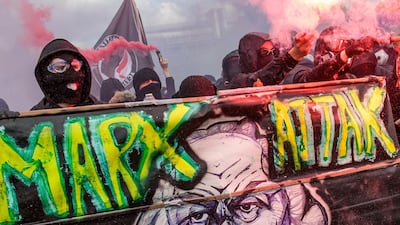 Masked protesters block a road ahead of clashes with French police. EPA/CHRISTOPHE PETIT TESSON