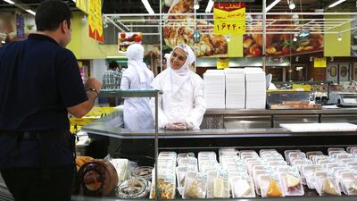 A deli station employee greets a customer at the Hyper Star market inside Isfahan City Center. John Moore / Getty Images