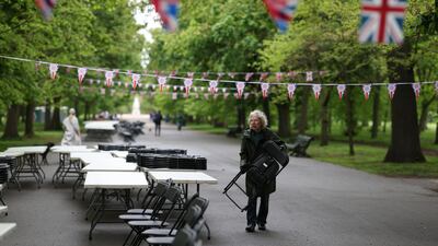 A volunteer sets up tables and chairs for the Big Lunch in Regent’s Park. Getty Images