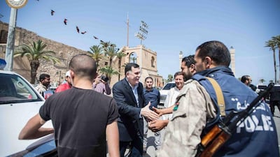 Fayez Serraj, prime minister of Libya’s UN-backed unity government, greets people on a street in Tripoli. AFP / Libya’s Prime Minister Facebook Page / March 30, 2016