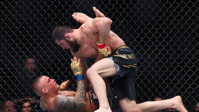Islam Makhachev and Dustin Poirier grapple during their lightweight title bout at UFC 302. AFP