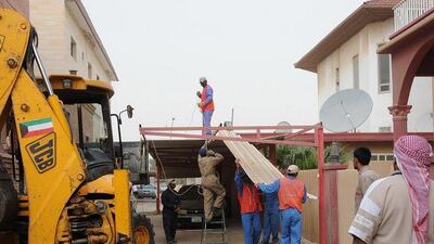 Kuwait Municipality workers dismantle illegal constructions in Salwa, Kuwait City, as directed by the government.