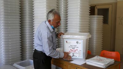 A Jordanian election official prepairs ballot boxes for the parliamentary elections which will be held on November 10, amid fears over rising number of the coronavirus disease cases, at a vote counting center in Amman. Reuters