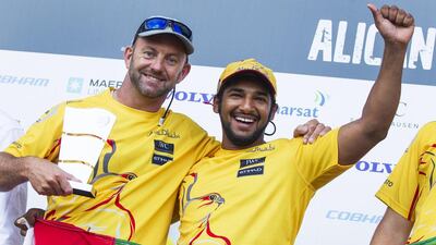 Azzam skipper Ian Walker, left, and Emirati sailor Adil Khalid receive their prize for finishing second in the Volvo Ocean Race in-port race in Alicante, Spain, on October 4, 2014. Ian Roman / Abu Dhabi Ocean Racing