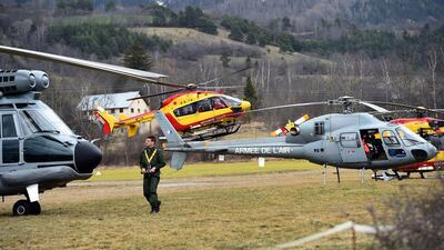 Helicopters of the French Air Force (back) and civil security services are seen in Seyne, south-eastern France on March 24, 2015, near the site where a Germanwings Airbus A320 crashed in the French Alps. Anne-Christine Poujoulat/AFP Photo