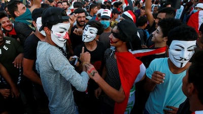 Demonstrators wearing masks attend an anti-government protest in Najaf. Reuters