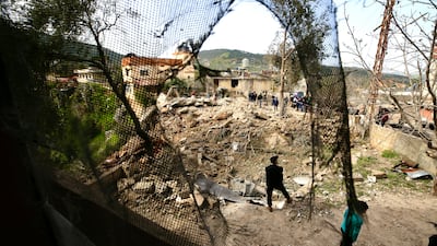 People inspect the damage at the site of an air strike in Habariyeh, in the south of Lebanon. EPA