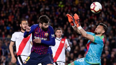 Barcelona's Gerard Pique heads the ball to score his side's first goal. AP Photo