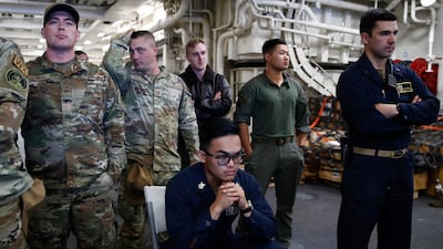 A joint Nasa and US military team watches as divers recover the Orion capsule. EPA