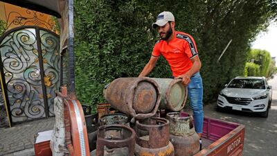 Mr Abbas unloads gas cylinders from his rickshaw. AFP