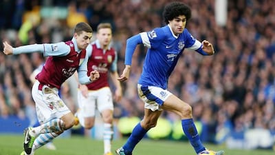 Everton's Marouane Fellaini edges looks to evade Aston Villa's Matt Lowton. Pic: Clive Brunskill/Getty
