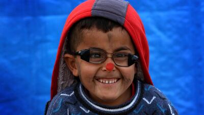 A displaced Iraqi boy, who fled the violence in Mosul, poses for a picture at the Hasan Sham refugee camp, about 40km east of Erbil. Safin Hamed / AFP Photo