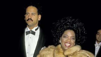 Oprah Winfrey wears a light brown fur coat to attend the 'Good Morning, Vietnam' premiere with Stedman Graham in Los Angeles, California on December 17, 1987. Getty Images
