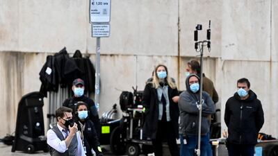 Tom Cruise uses a walkie-talkie during the shooting of 'Mission: Impossible 7' at Piazza Venezia in Rome, Italy on November 29, 2020. EPA