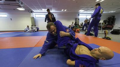 Stacy Duchscherer, 50, from Canada, top, and Stuart Penn, 39, from Jersey, UK, both para-jiu jitsu players, during a practice session during the Abu Dhabi World Jiu Jitsu Festival at the Ipic Arena in Abu Dhabi on April 13, 2017. Christopher Pike / The National