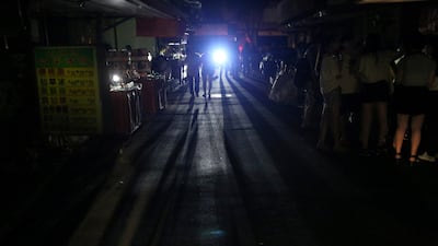 People walk on a street during a massive power outage in Taipei, Taiwan August 15, 2017. REUTERS/Stringer TPX IMAGES OF THE DAY