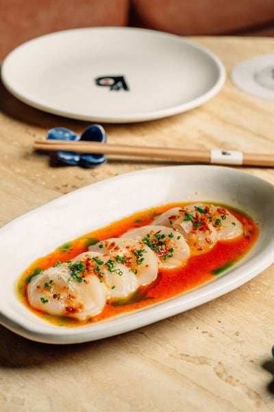 Hotate, or scallops, served with umeboshi butter, made with a sour and salty Japanese pickled fruit. Photo: Yubi
