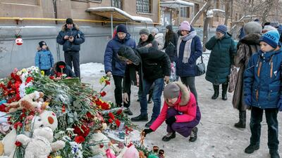 People gathered at the site of the partially collapsed apartment block in Magnitogorsk to pay their respects on Thursday. Reuters