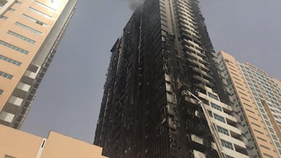 An Ajman Police criminal laboratory report found that a flaming material fell from a flat and landed on construction waste in front of Tower Eight, starting the fire, but it could not be said with certainty what that material was. AP Photo / Fay Abuelgasim