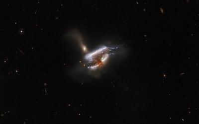 The Hubble Space Telescope captures a striking image of three distant galaxies merging into one. Photo: Hubble Space Telescope / European Space Agency