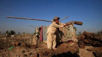 Aqeel, 12, helps to move bricks as his family searches for belongings lost nearly two months ago when heavy floods destroyed their home near Nowshera, in Pakistan's Khyber Pakhtunkhwa province, in October last year.