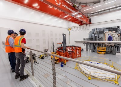 Commonwealth Fusion workers assemble a frame that will hold a demonstration reactor. Bloomberg