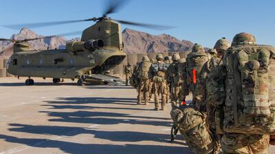 Soldiers attached to the 101st Resolute Support Sustainment Brigade, Iowa National Guard and 10th Mountain, 2-14 Infantry Battalion, load onto a Chinook helicopter in Afghanistan. US army via Reuters