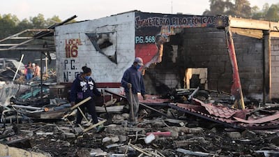 People search amid the debris. Ronaldo Schemidt / AFP Photo