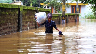A young man wades through a flooded street in Kochi, Kerala state, India. According to reports, the region is on a high alert with schools and offices been closed due to the rising water levels of Periyar river after the gates of the Idukki reservoir were opened. The Indian state of Kerala has been hit by heavy rains that caused floods and reportedly killed at least 20 people. EPA